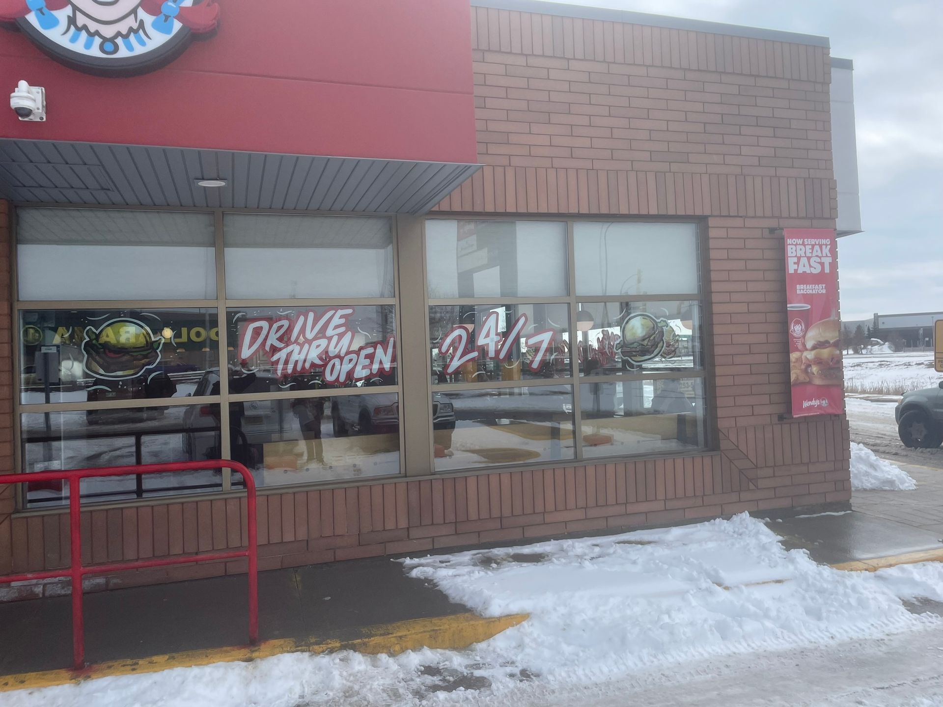 A brick building with a sign that says drive thru open