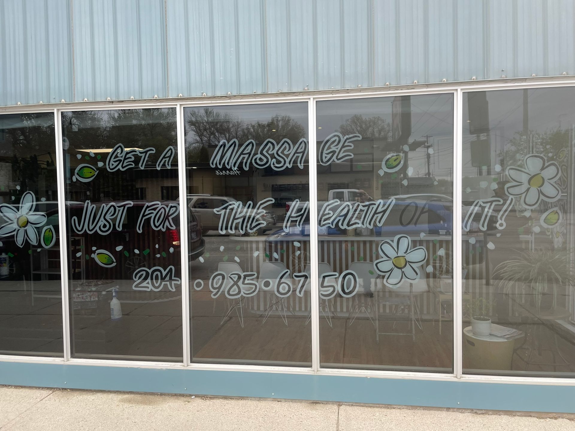A building with a window that says get a massage just for the health of it