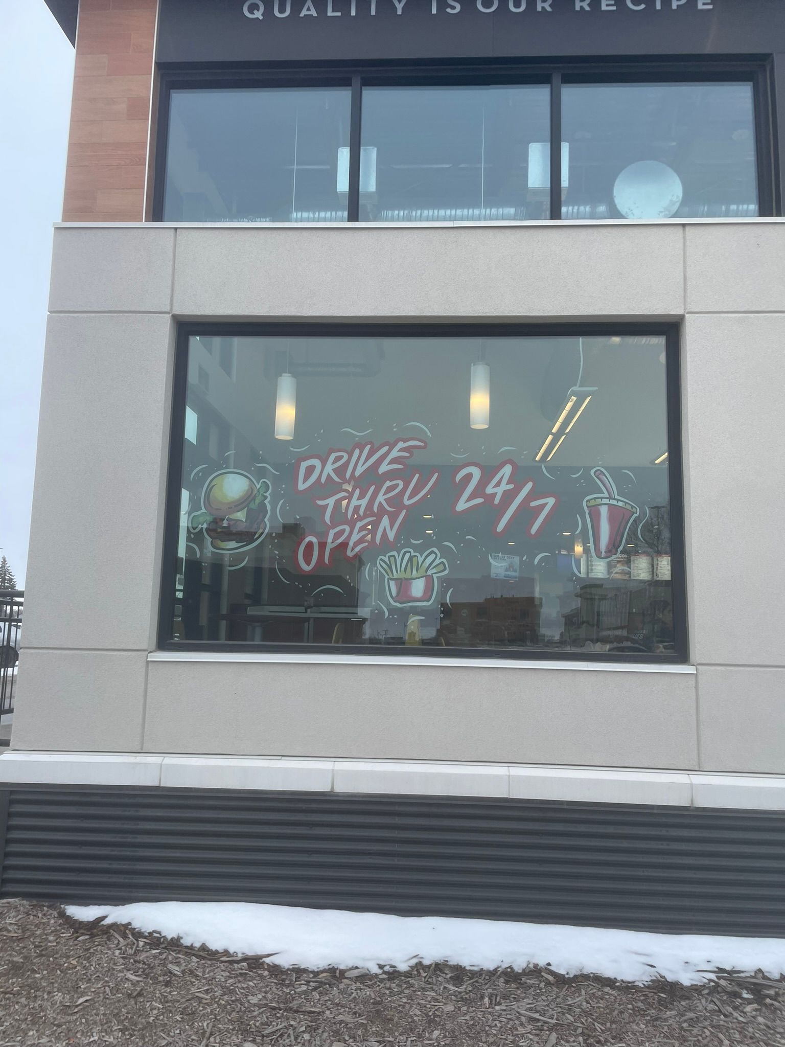 A building with a window that says drive thru 2017 open