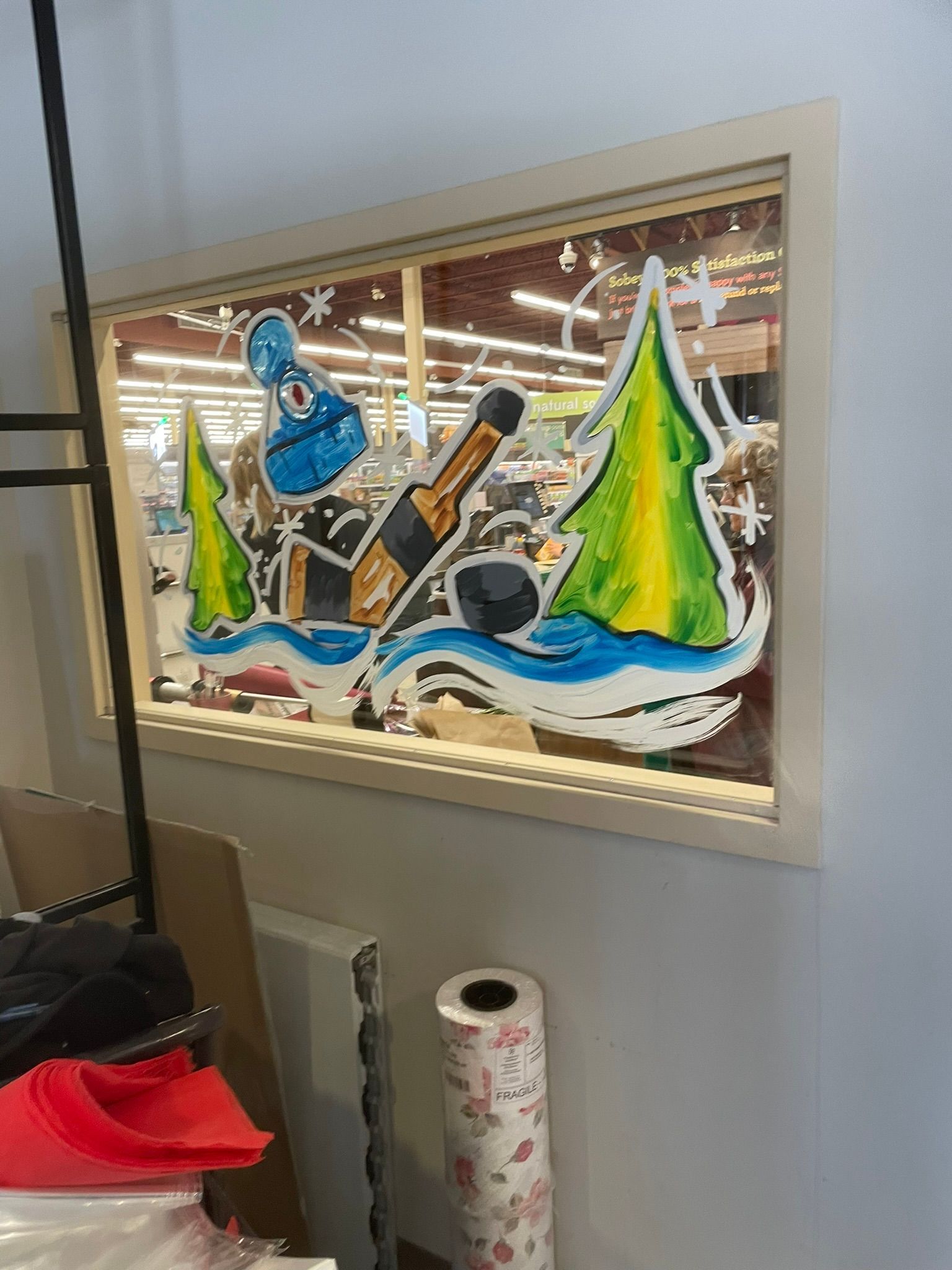 A window with a painting on it in a store.