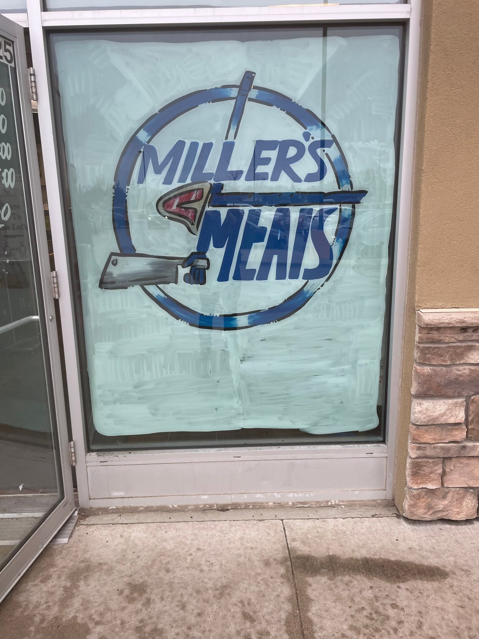 A window with a sign that says miller 's meats on it.