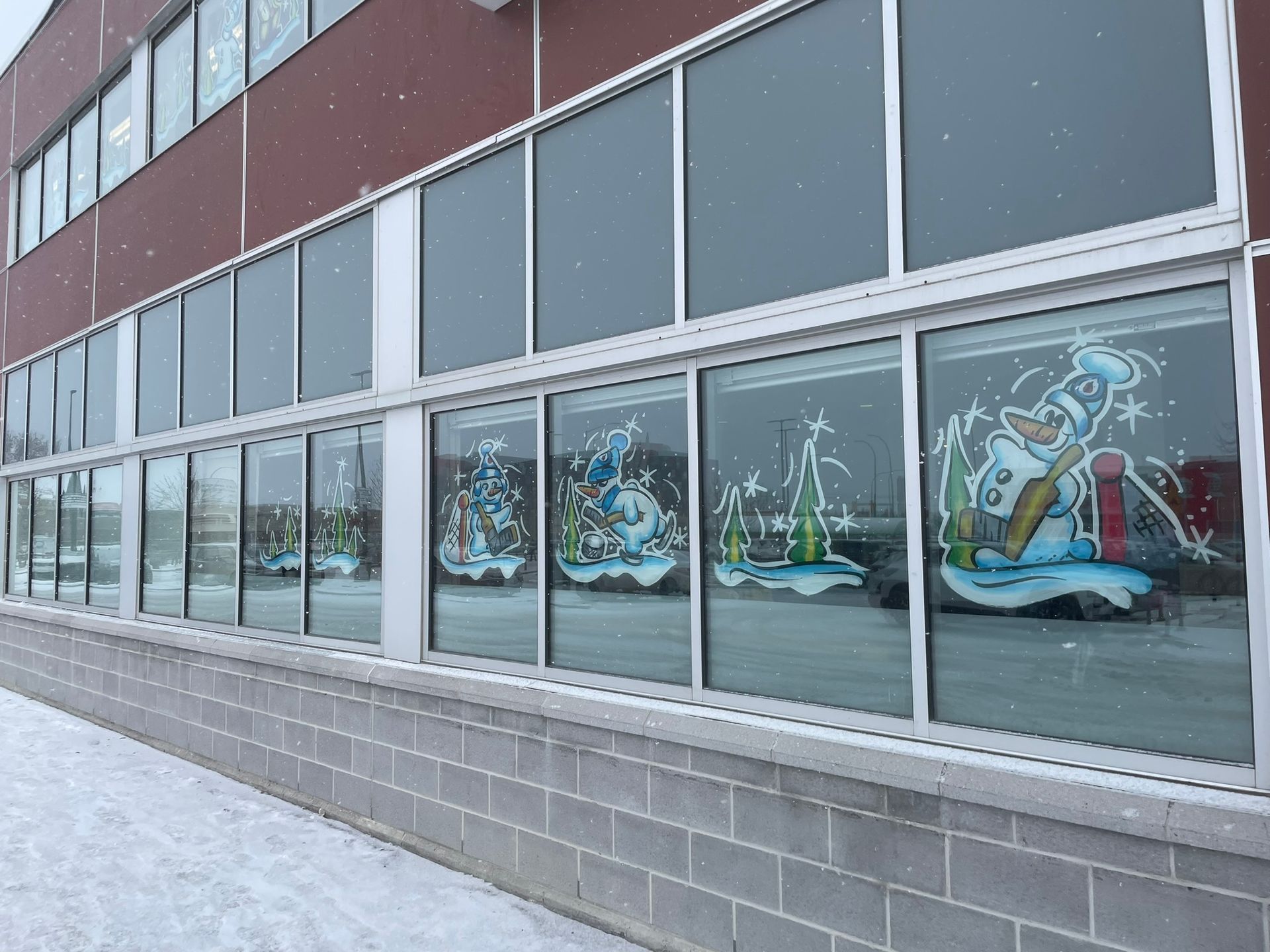 A building with a lot of windows and snowmen painted on them