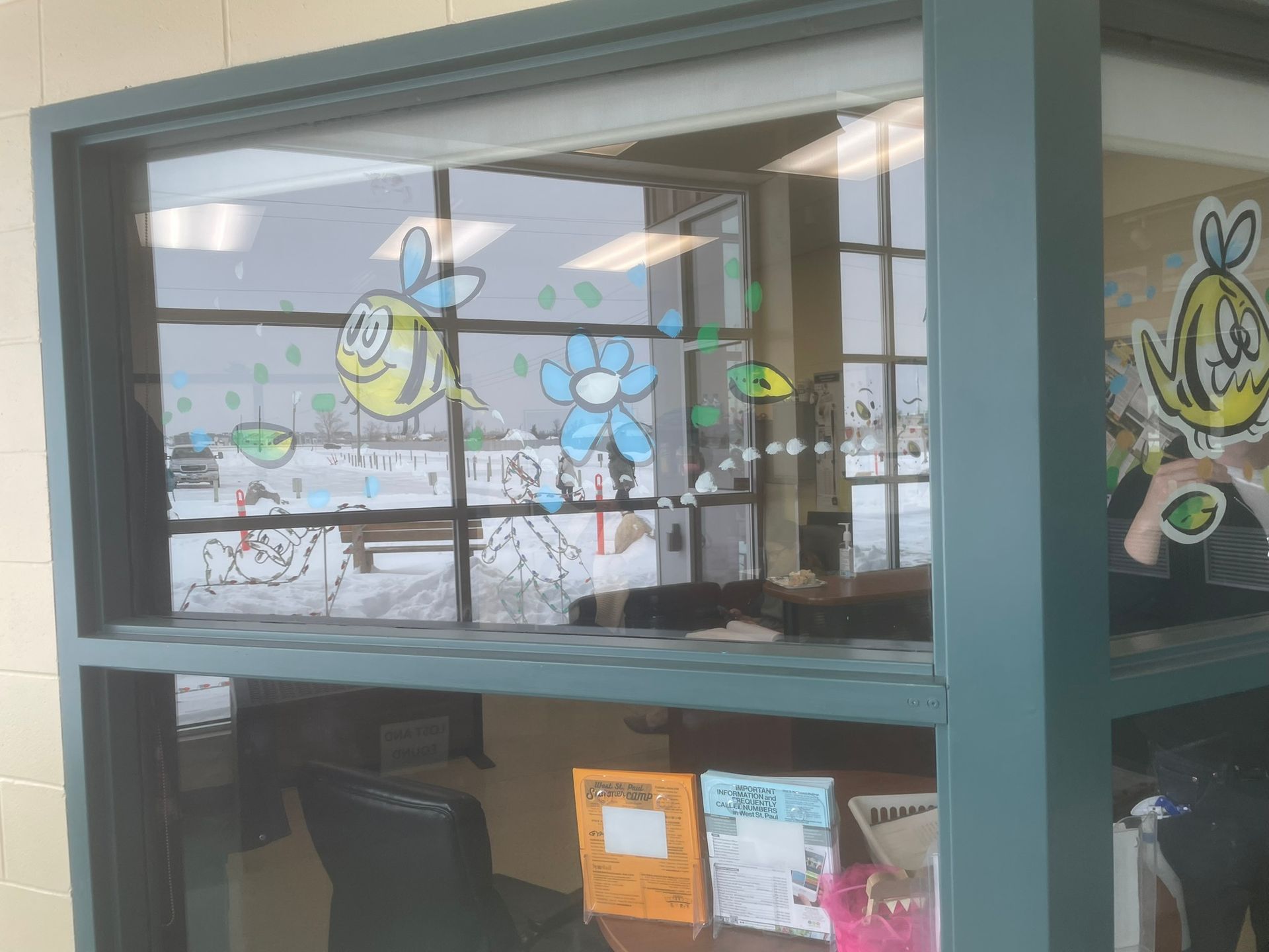 A window with bees and flowers painted on it