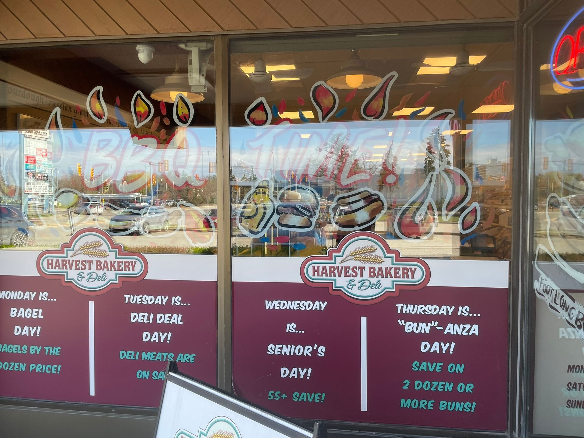 A harvest bakery has a menu on the window