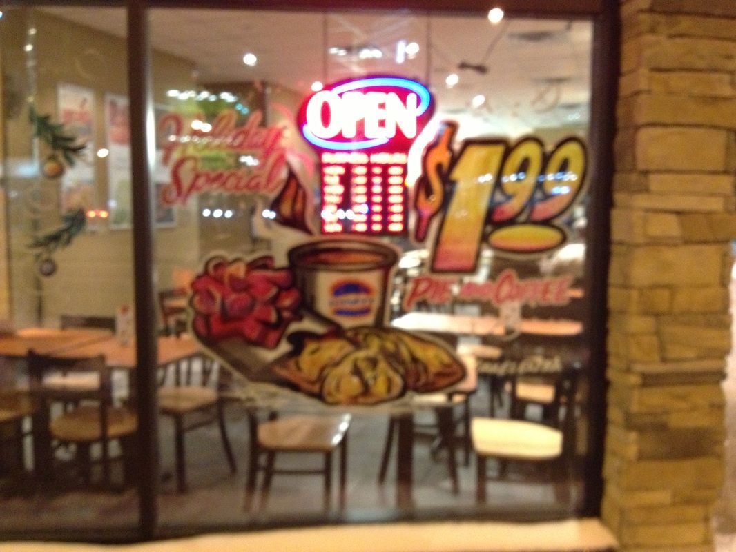 A restaurant with a sign that says open $ 1.99