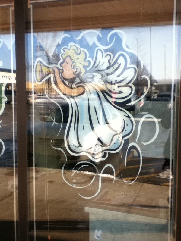 A drawing of an angel blowing a trumpet on a window
