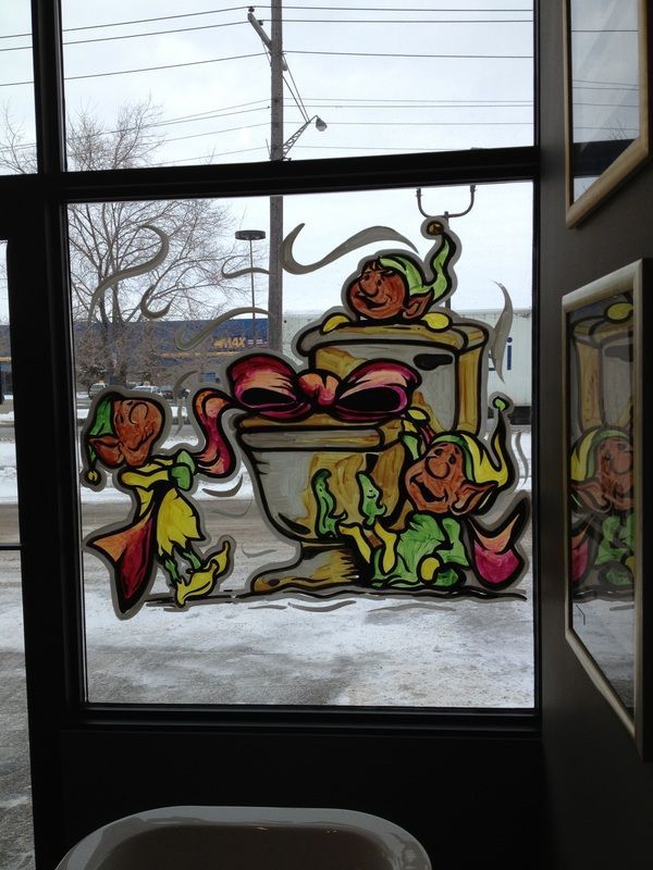 A stained glass window with a picture of elves on it