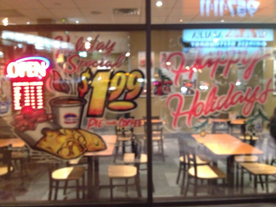 A restaurant with a sign that says happy holidays