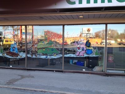 A store front with christmas decorations on the windows