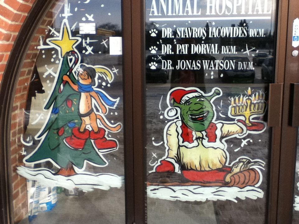A sign for an animal hospital has a christmas tree on it