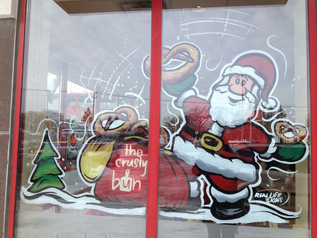 A window with a picture of santa and the words the crusty bun