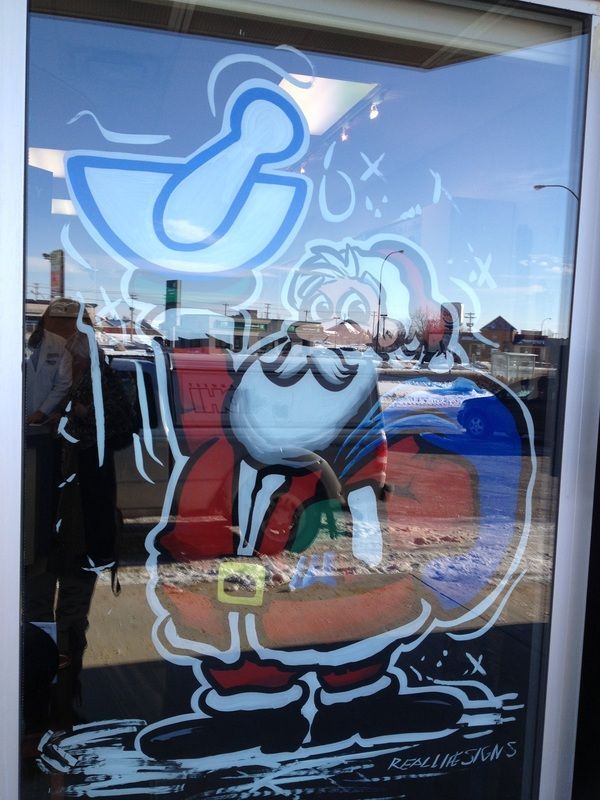 A drawing of santa claus is on a glass window