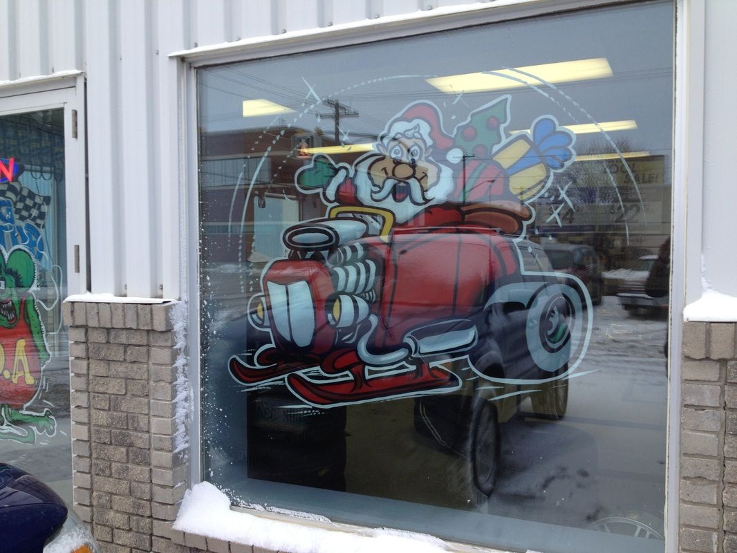 A window with a picture of santa claus in a red car