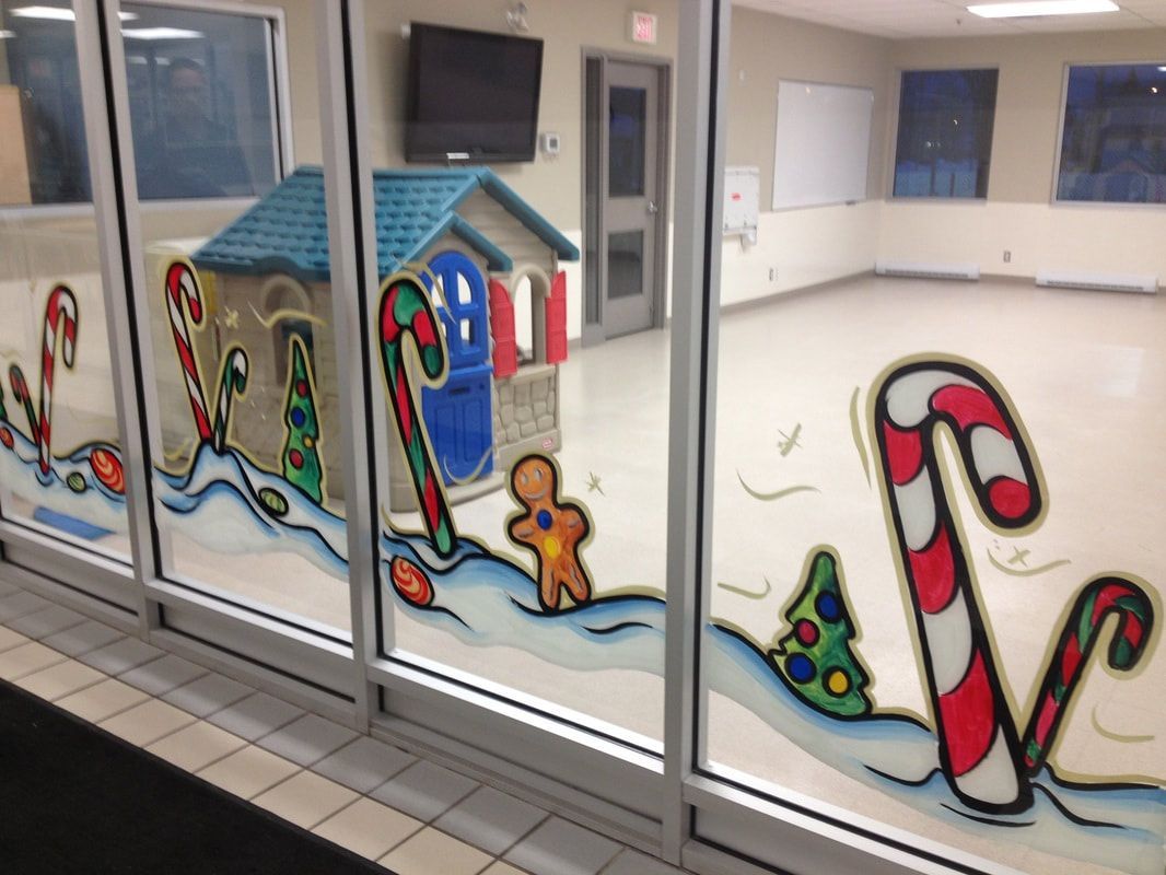 A room with candy canes and gingerbread men painted on the windows