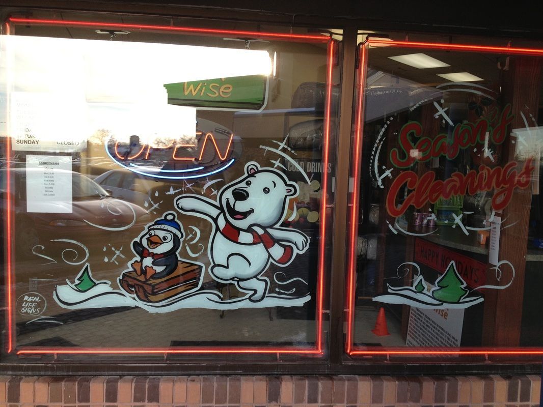 A window with a polar bear and penguin on it
