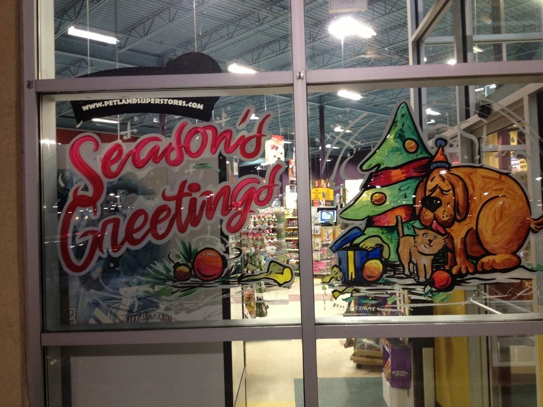 A window with a picture of a dog and a christmas tree says season 's greetings