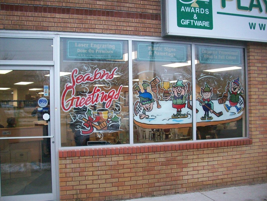 A brick building with a sign that says awards and giftware
