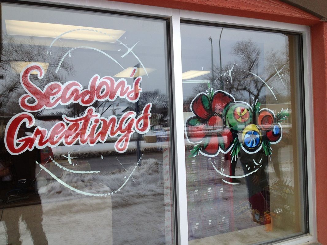 A window with the words seasons greetings painted on it