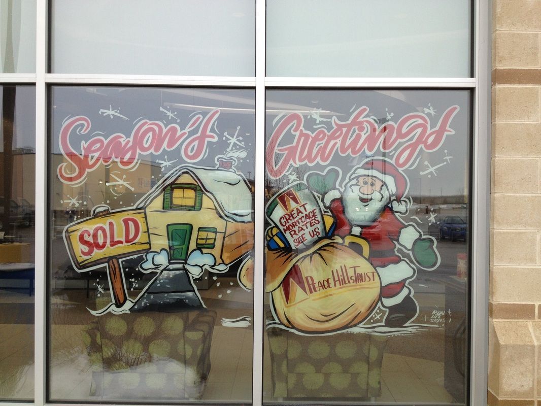 A window with a picture of santa claus and a sold sign on it.