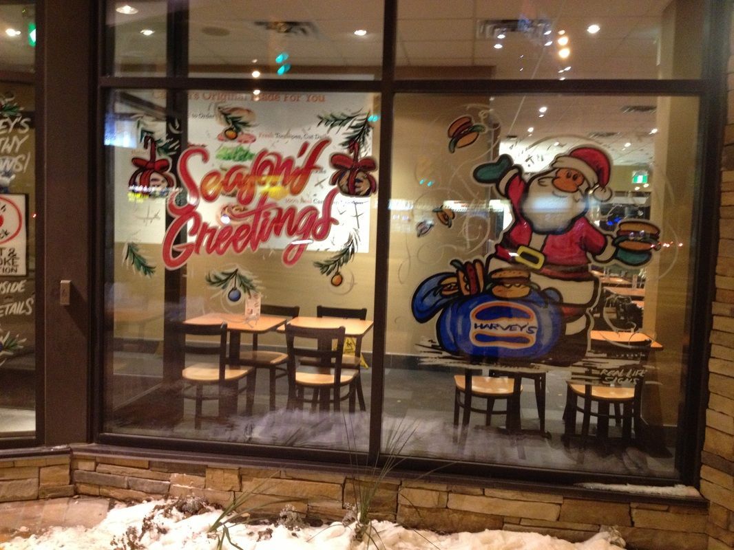 A restaurant with a christmas decoration on the window