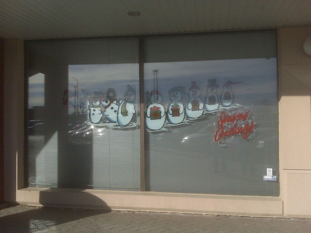 A window with a picture of penguins on it