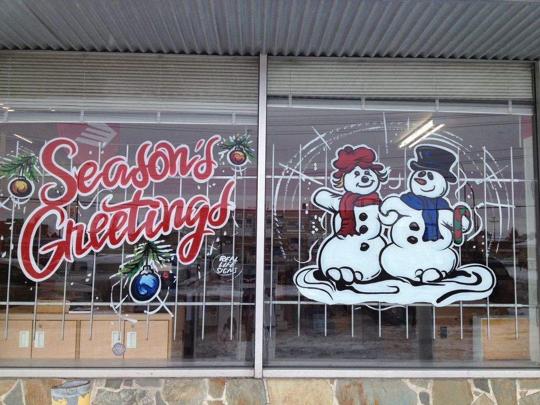 A window with two snowmen painted on it and the words season 's greetings