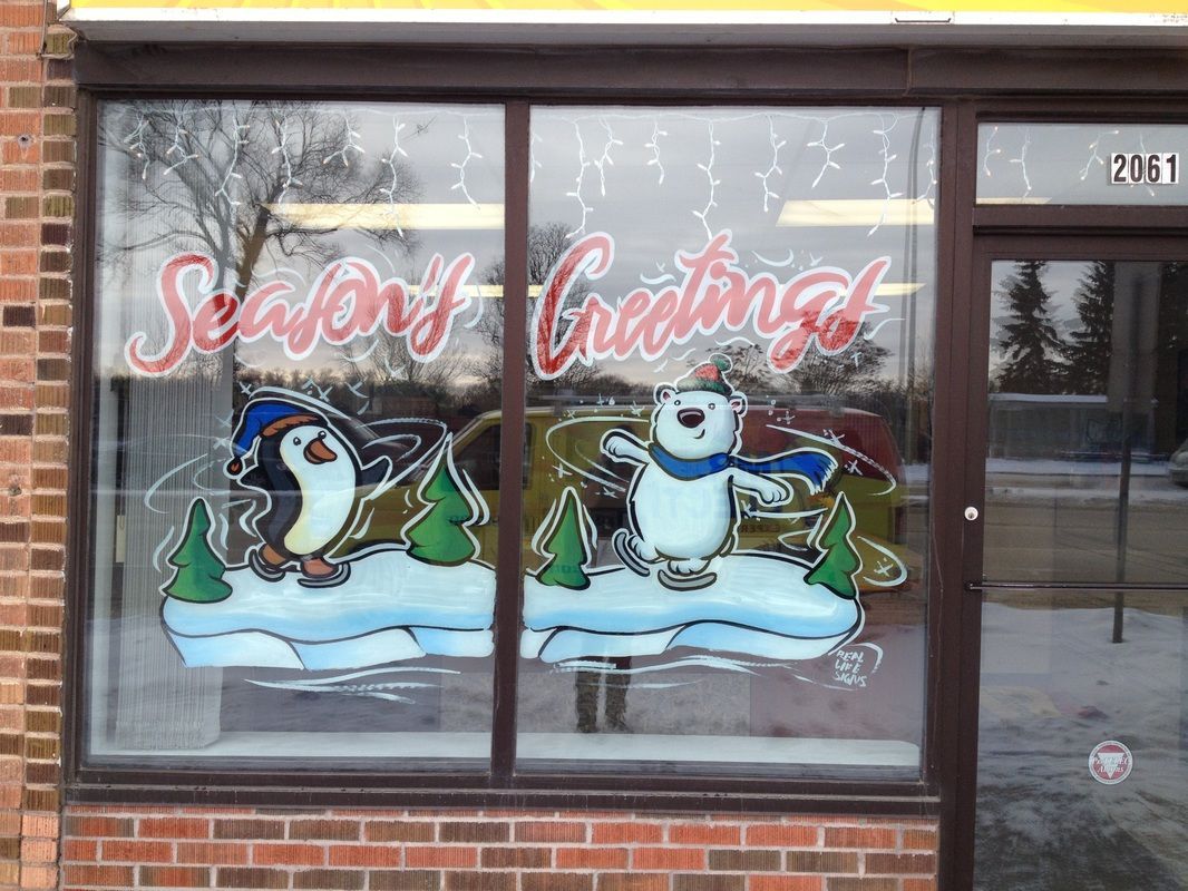 A window with penguins and snowmen painted on it