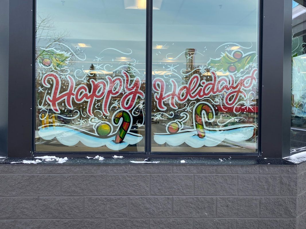 A window with a christmas decoration on it that says `` happy holidays ''.