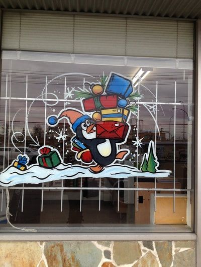 A window with a penguin and gifts on it