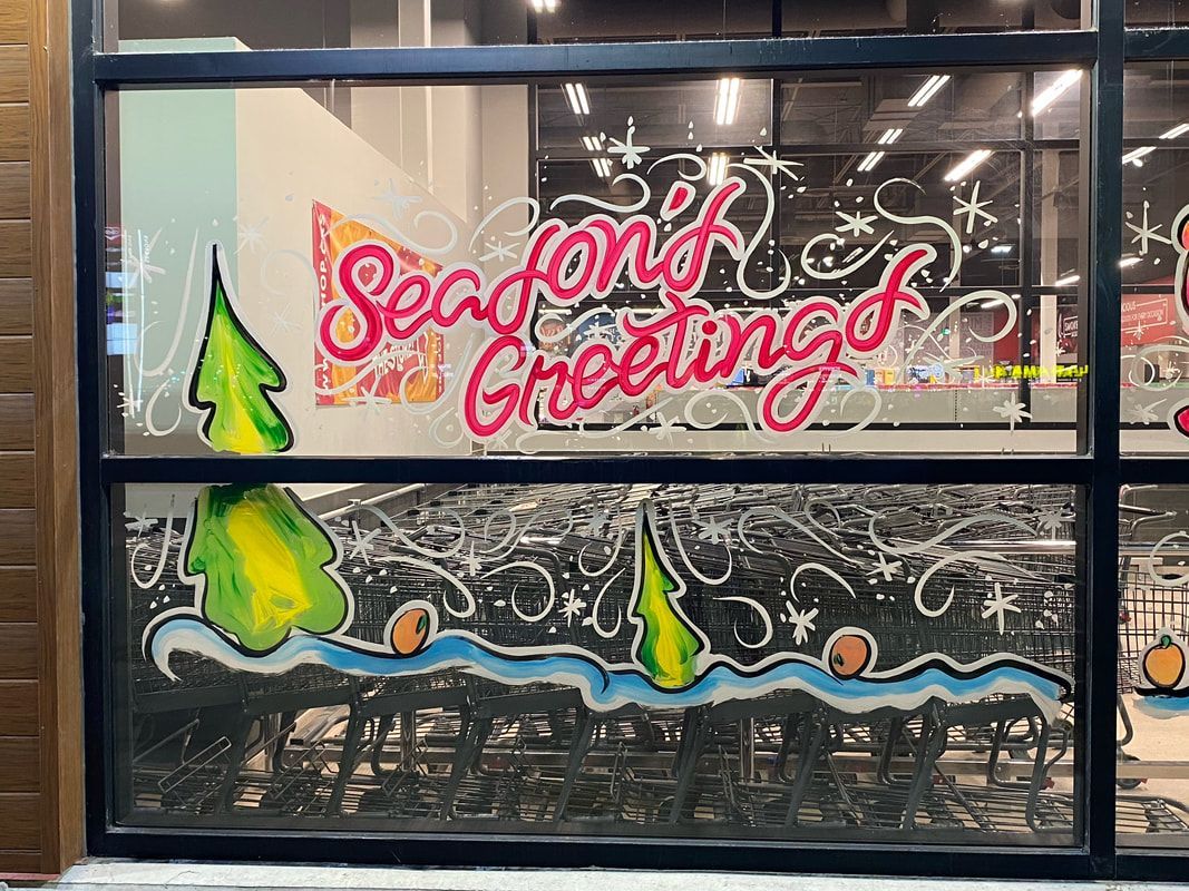 A window with graffiti on it that says `` season 's greetings ''.