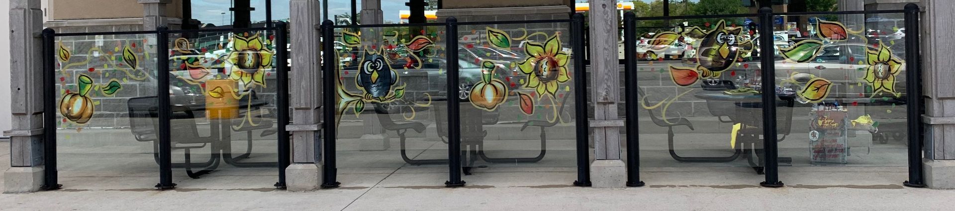 A picture of a fence with flowers in the background.