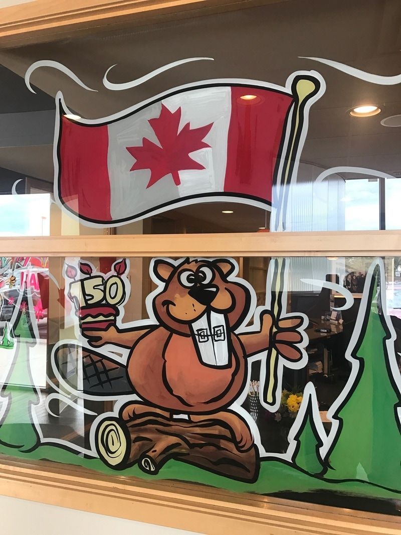 A cartoon of a beaver holding a canadian flag