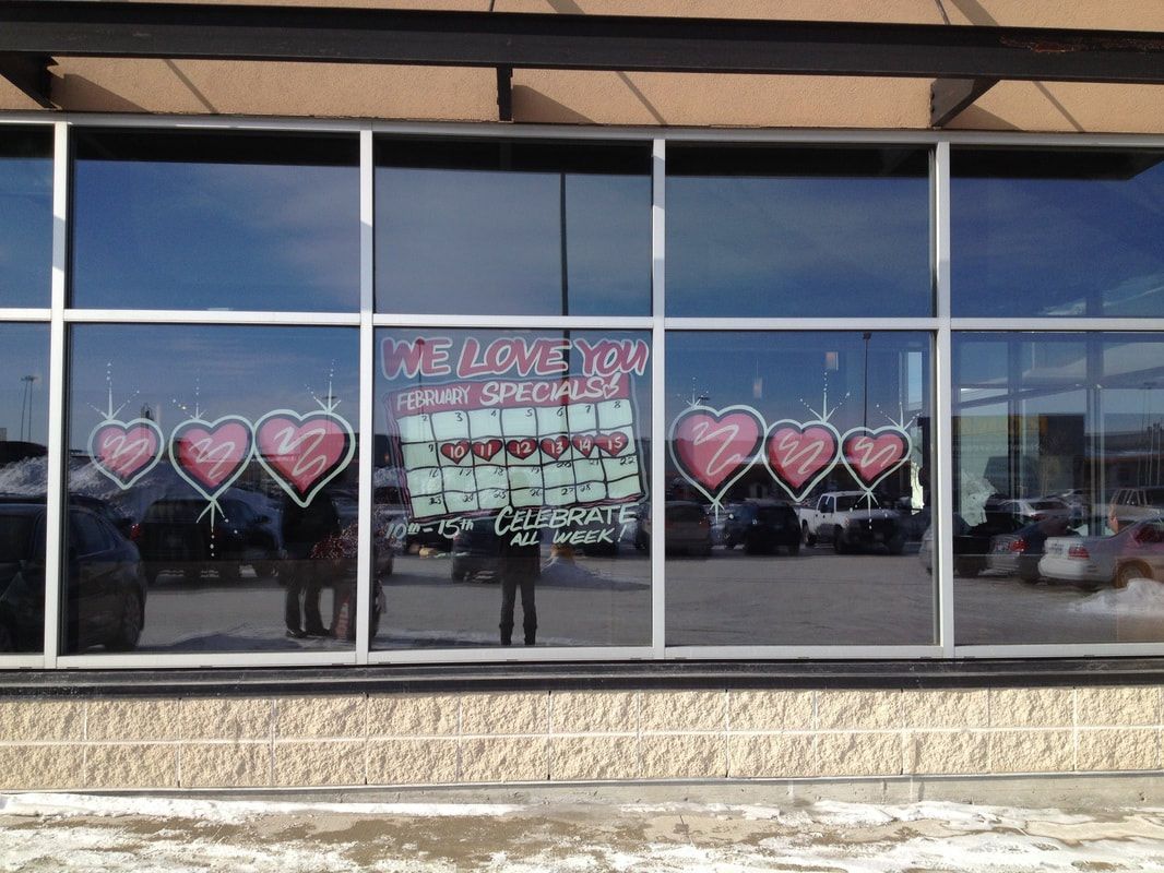 A store front with hearts painted on the windows