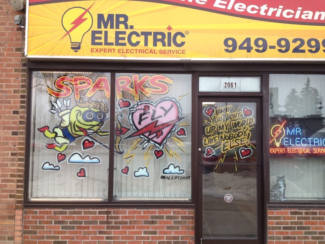 A brick building with a yellow sign that says mr. electric