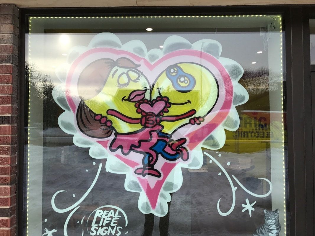 A drawing of a man and woman in a heart on a window