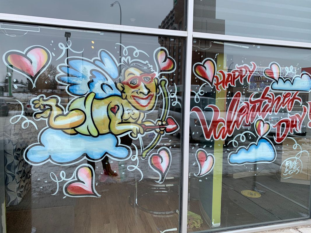 A window with a drawing of a cupid holding an arrow and hearts on it.
