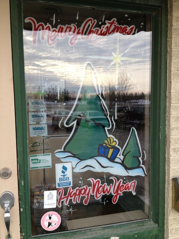 A window with a christmas tree and the words merry christmas and happy new year