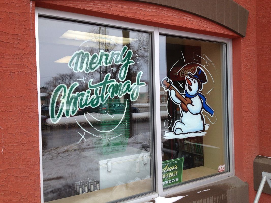 A window with a snowman on it that says merry christmas