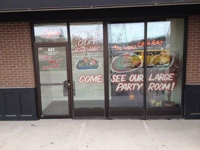 The front of a restaurant with a sign that says `` come see our large party room ''.