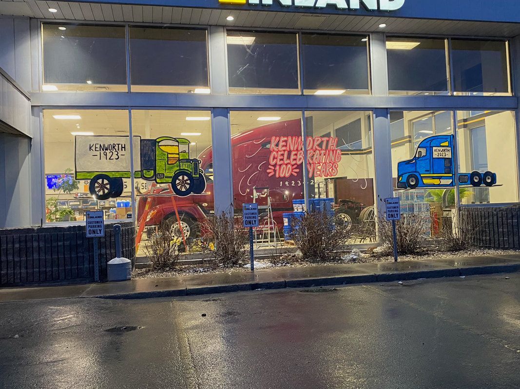 A store front with a lot of windows and a truck in the window.
