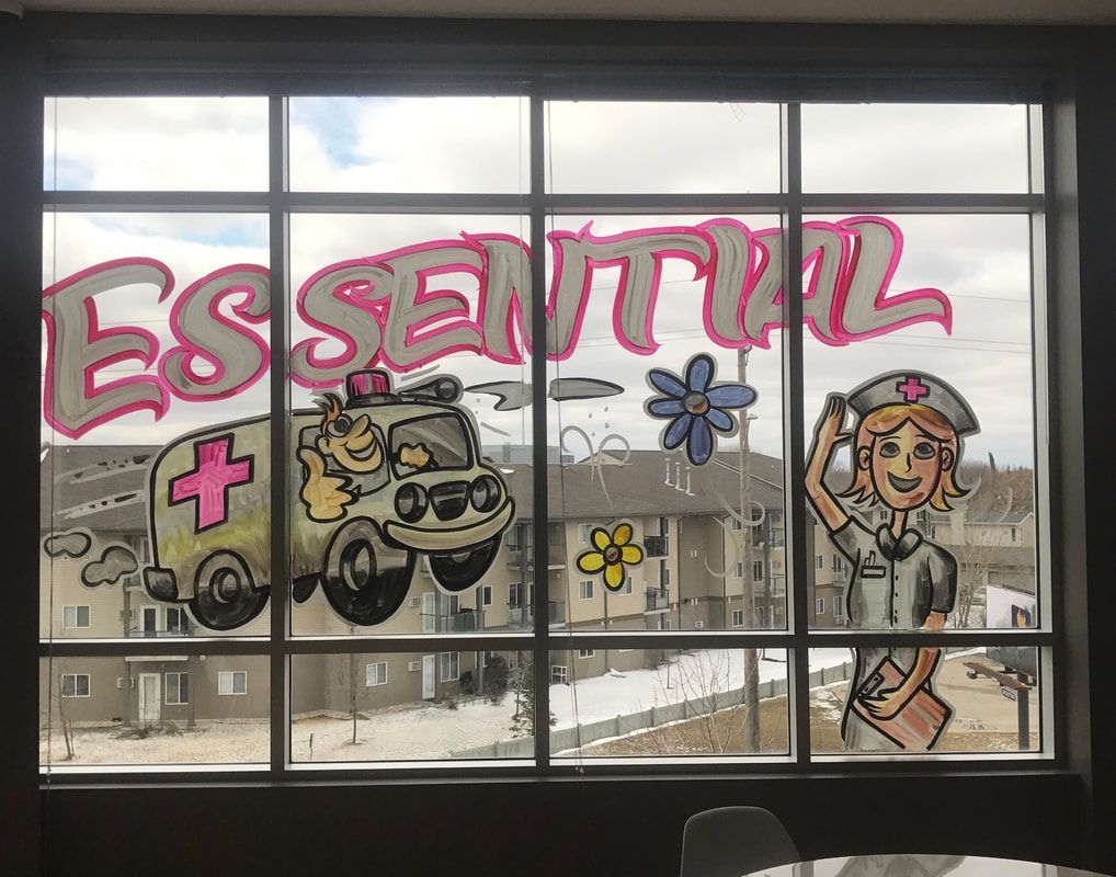 A window with a cartoon of an ambulance and a nurse painted on it.