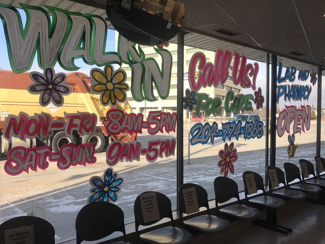 A waiting room with chairs and flowers painted on the windows.