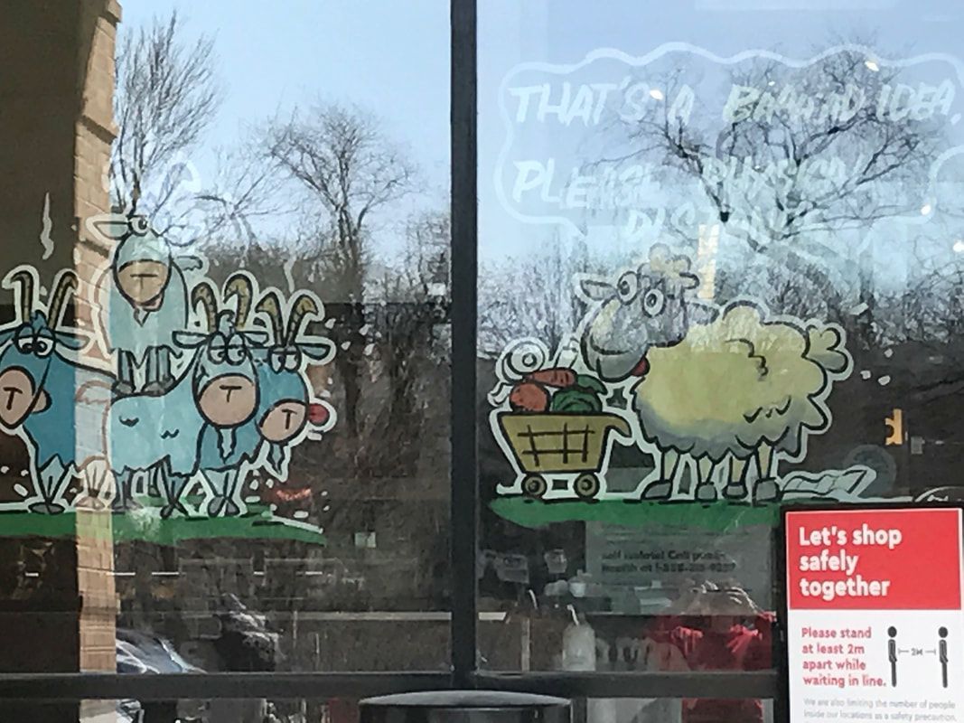 A store front with a drawing of a sheep on the window.