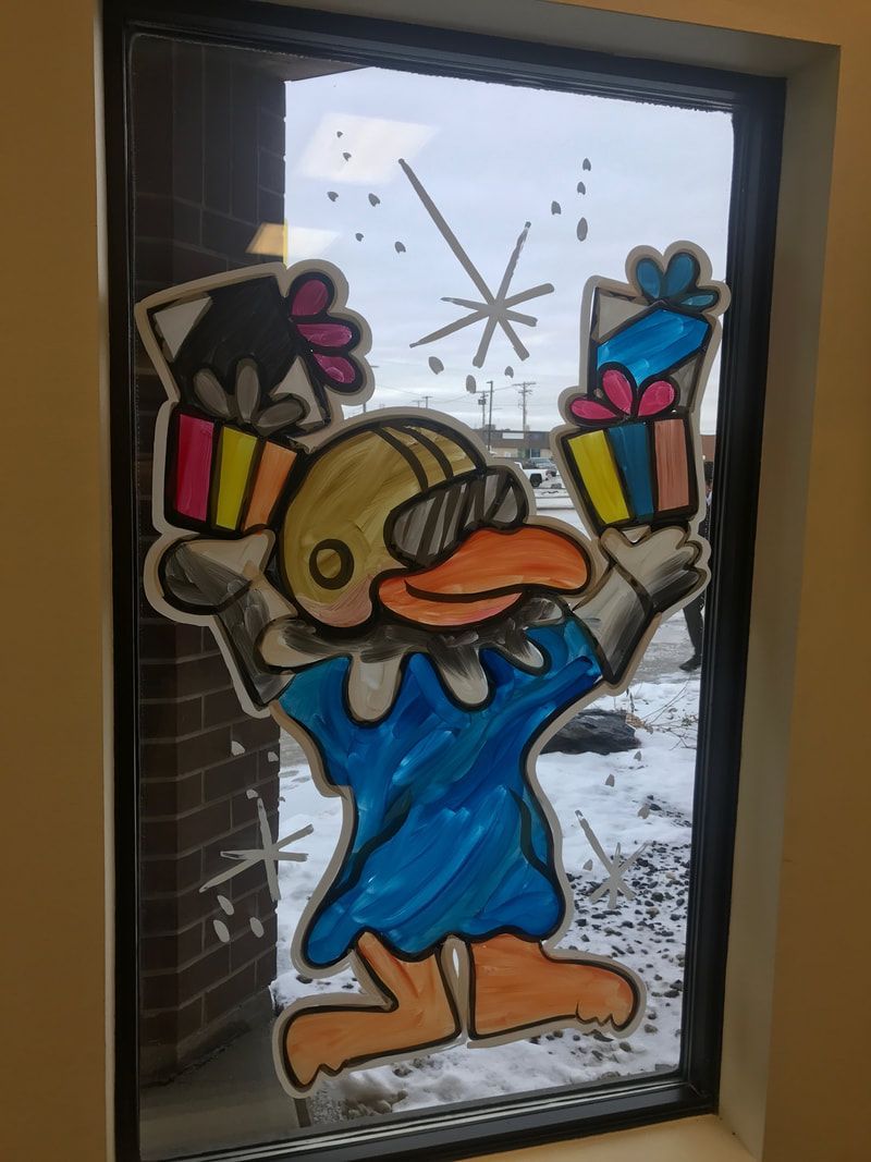 A window with a drawing of a duck holding gifts