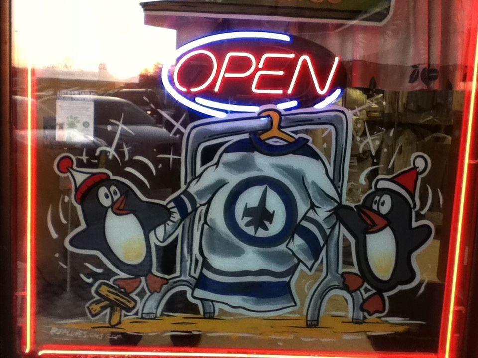A neon sign that says open with penguins on it