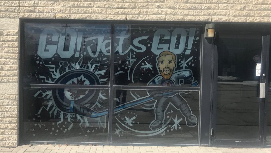 A window with a drawing of a man and the words `` go jets go '' on it.