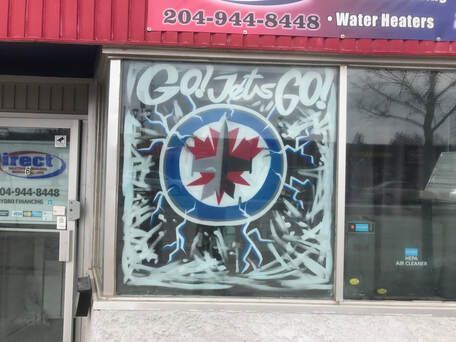 A store front with a sign that says go jets go