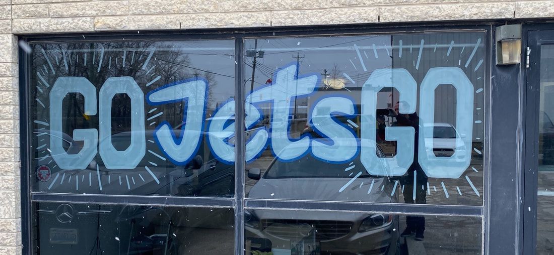 The word go is painted on the window of a building.