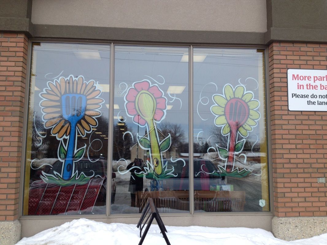 A store front with flowers painted on the windows