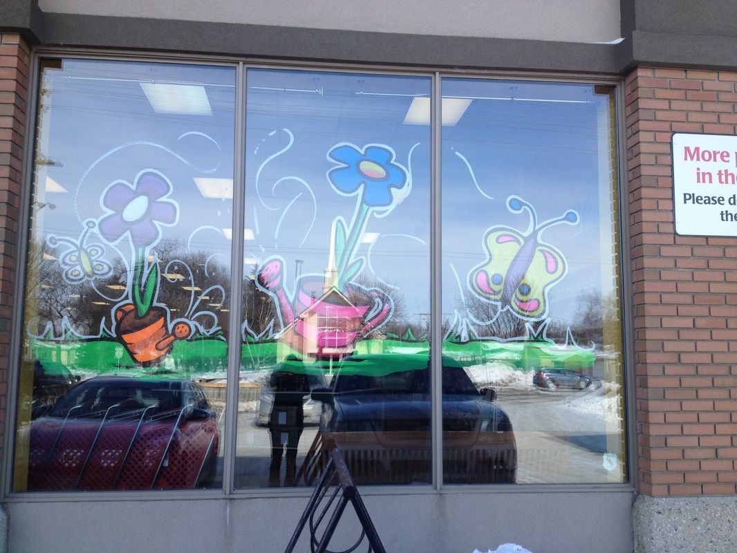 A window with flowers and a sign that says more in the window